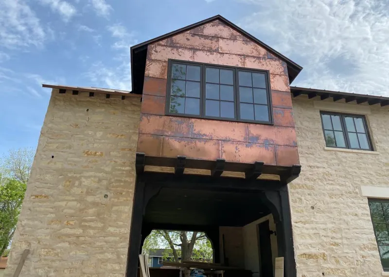 Copper metal panel facade on a stone building for Skylight Installation in Swannanoa