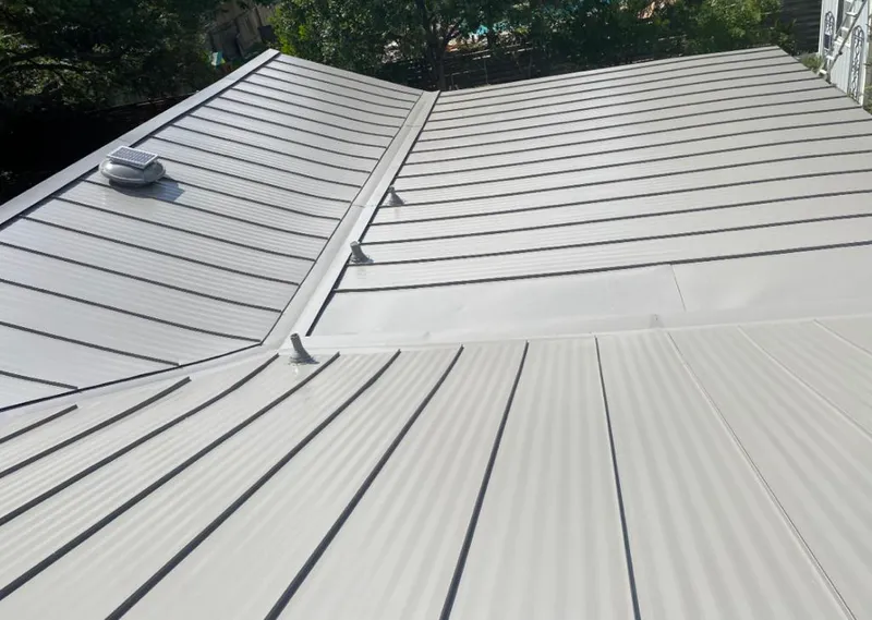 Solar attic fan installed on a metal roof for Roof Ventilation in Swannanoa